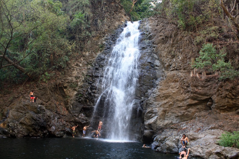 The lower Montezuma waterfall dropping into a pool with swimmers