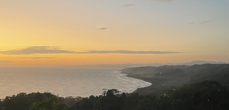 Sunset over Santa Teresa bay seen from the hills of Mal País